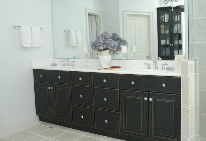 Custom Black Bathroom Cabinets with his and her sinks by Noles Cabinets